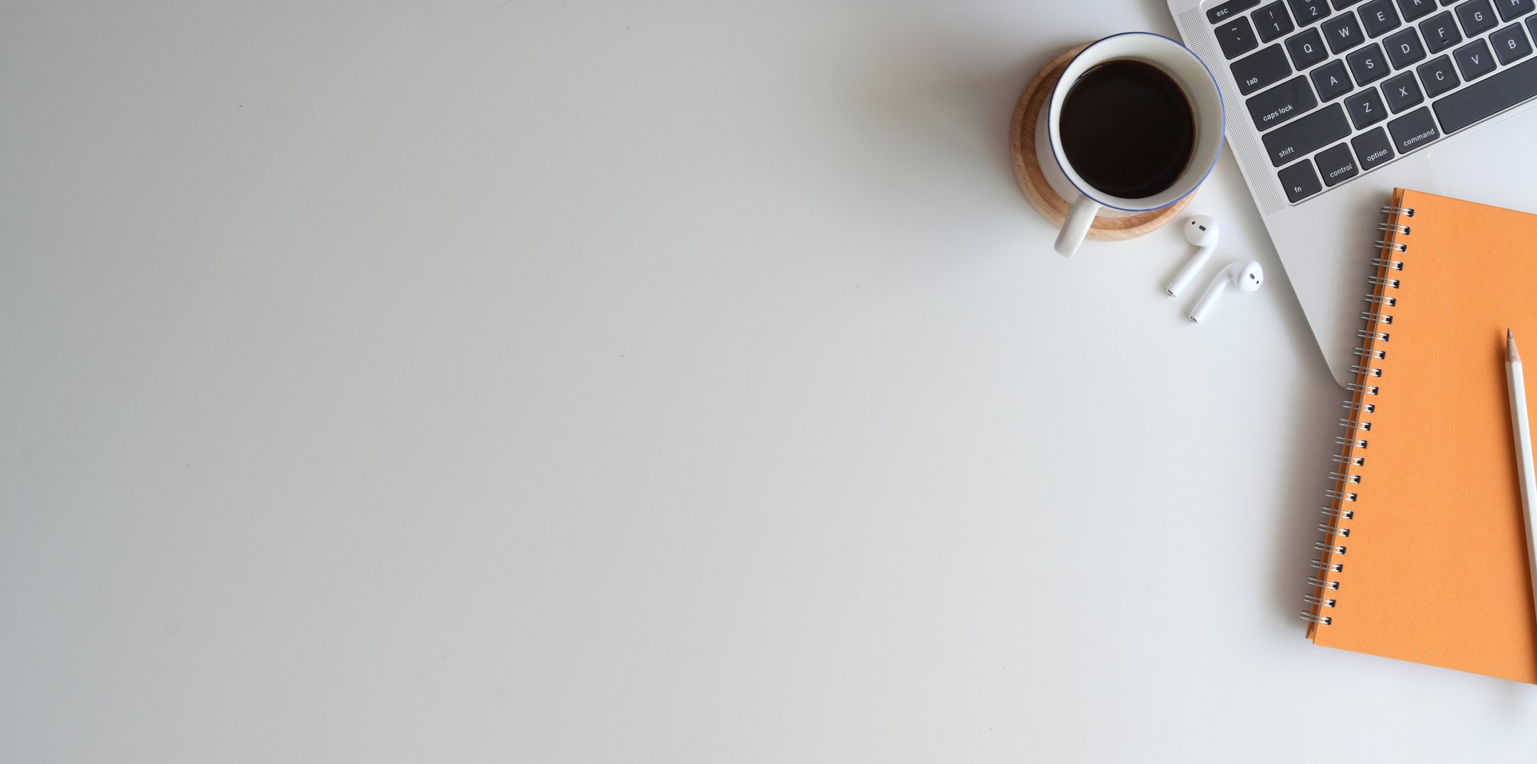 Arranged coffee with gadgets and notepad